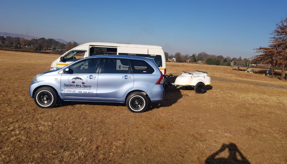Southern Berg Shuttle Avanza towing its luggage trailer in a winter grass field near Underberg