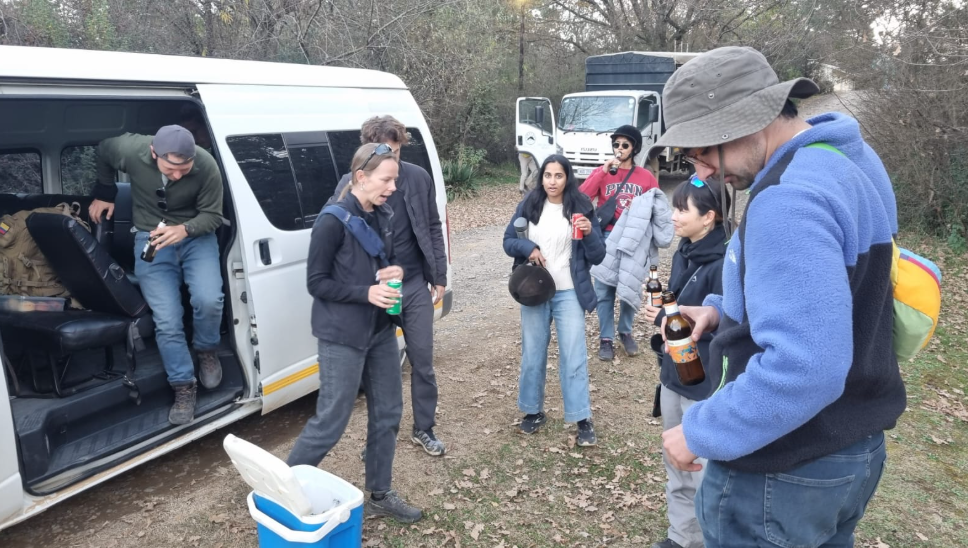 Passengers gathering at the shuttle minibus for a group transfer stop