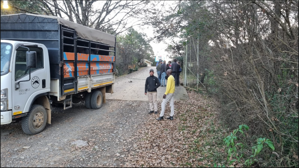 Shuttle group waiting at a farm road pick-up point in the Berg foothills