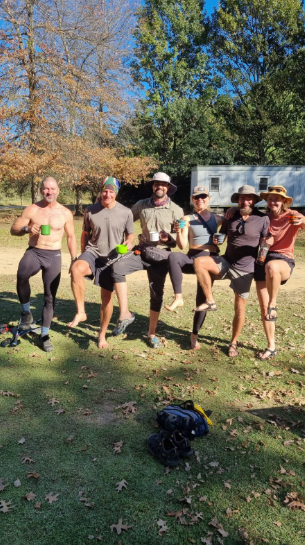 Happy hiking group celebrating at the end of a trail after their shuttle transfer